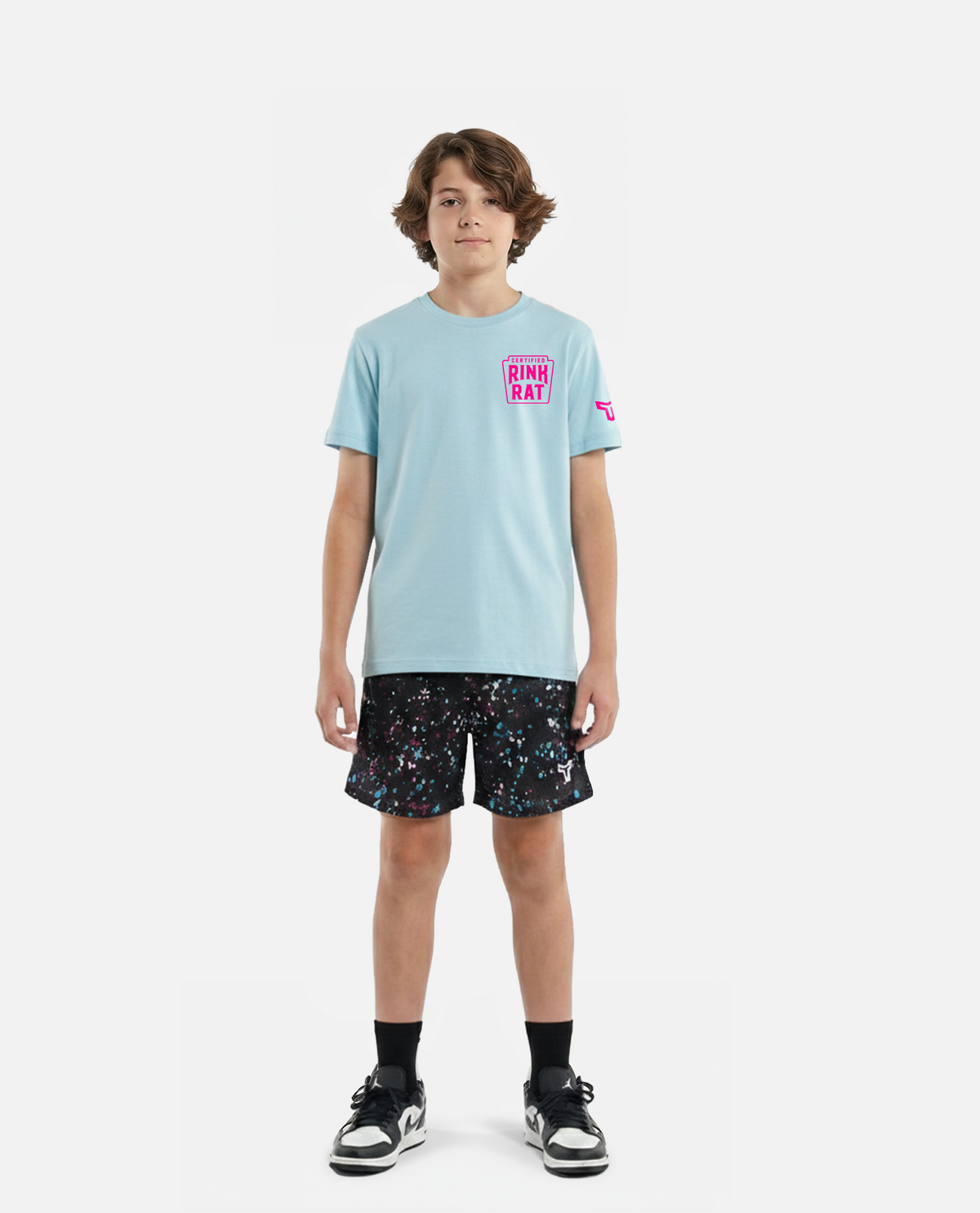 kid wearing a black titan battlegear t-shirt and colorful shorts on a white background