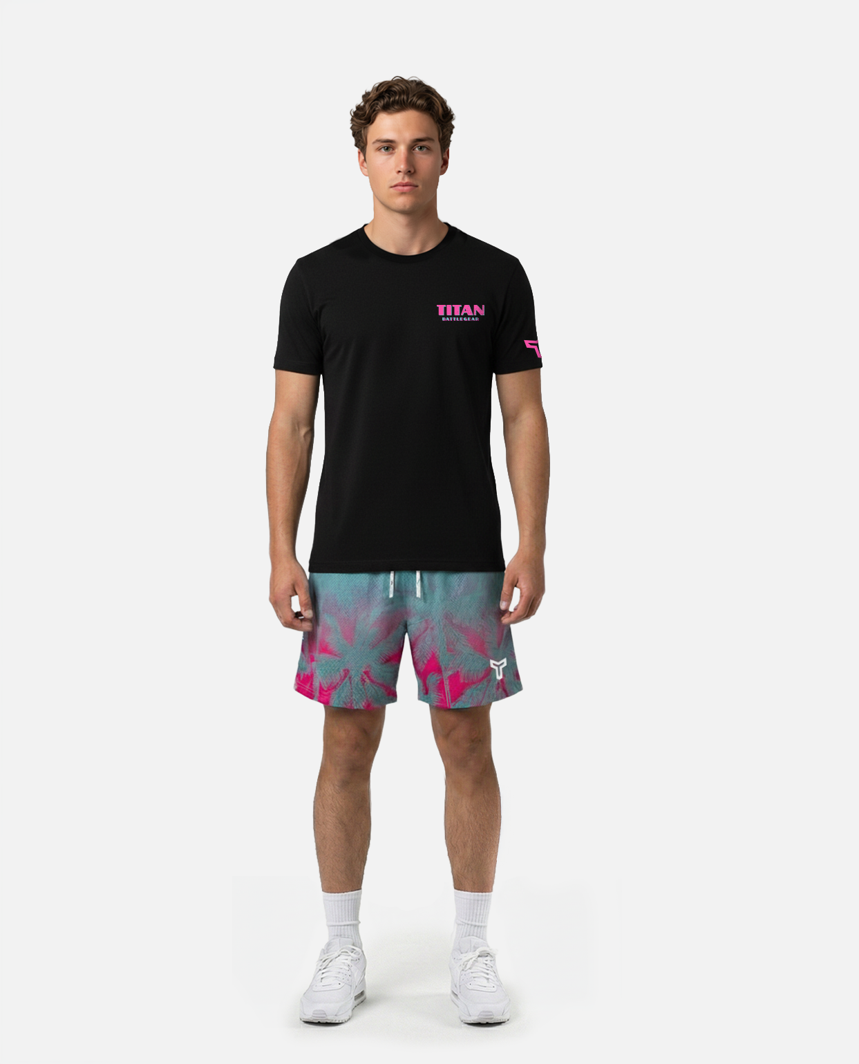 Person wearing a Titan battlegear teal and pink shorts with palm tree pattern on a white background