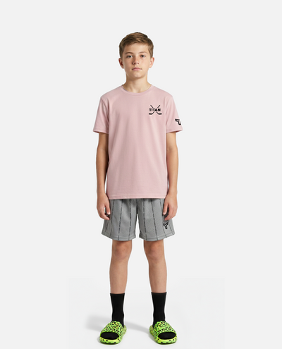 Young person wearing a black titan battlegear t-shirt with a logo and gray checkered shorts on a white background