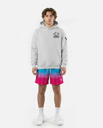 young male wearing Titan battlegear colorful shorts with a gradient design on a white background